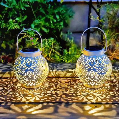 2-Pack Outdoor Solar Hanging Lanterns - Metal LED Decorative Lights for Garden, Patio, Courtyard, Lawn, and Tabletop with Hollowed-Out Design in White.