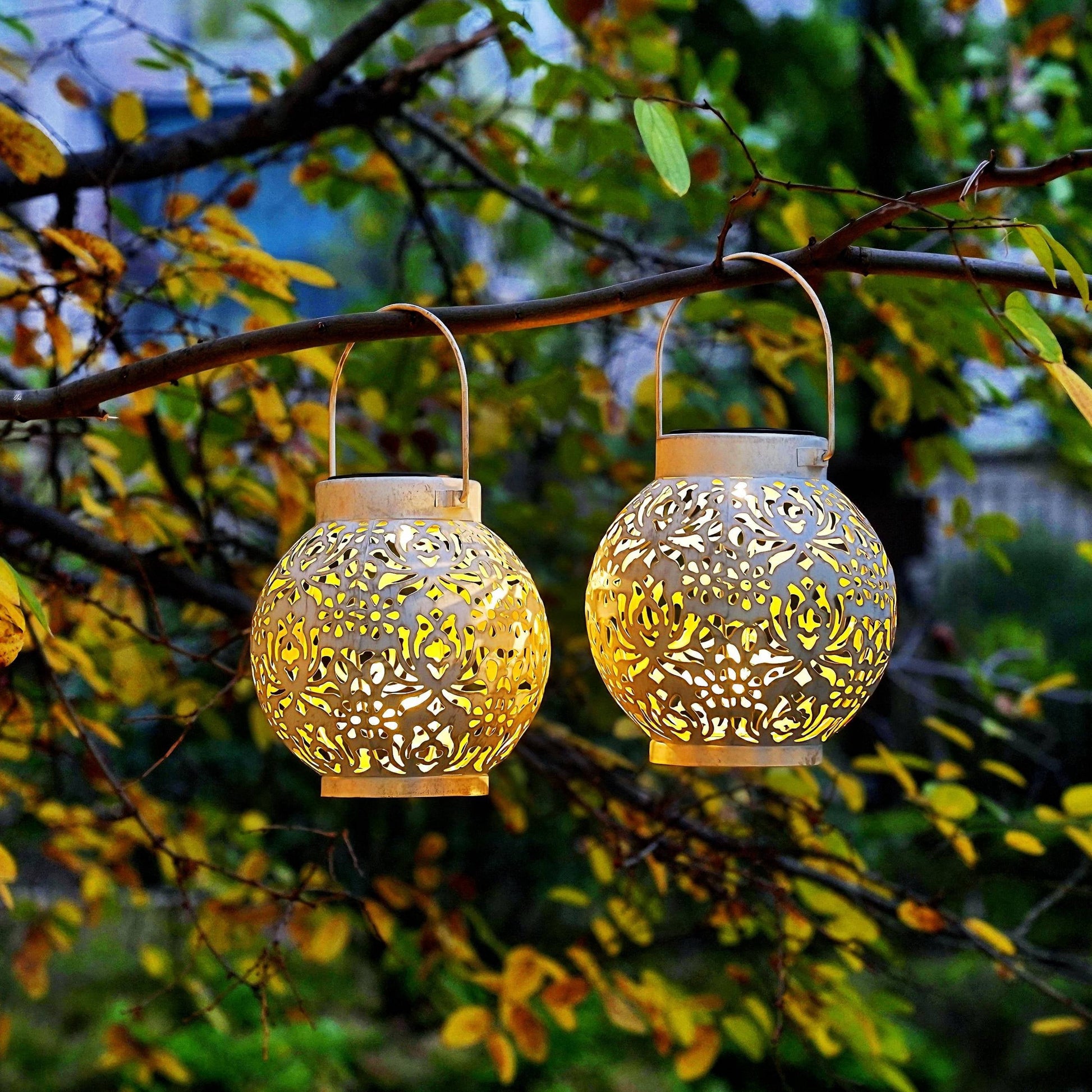 2-Pack Outdoor Solar Hanging Lanterns - Metal LED Decorative Lights for Garden, Patio, Courtyard, Lawn, and Tabletop with Hollowed-Out Design in White.